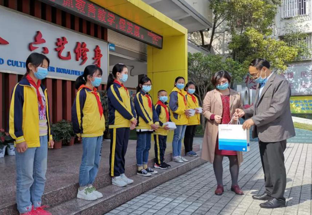 徐经理与胡主任向孩子捐赠口罩与消毒液.jpg
